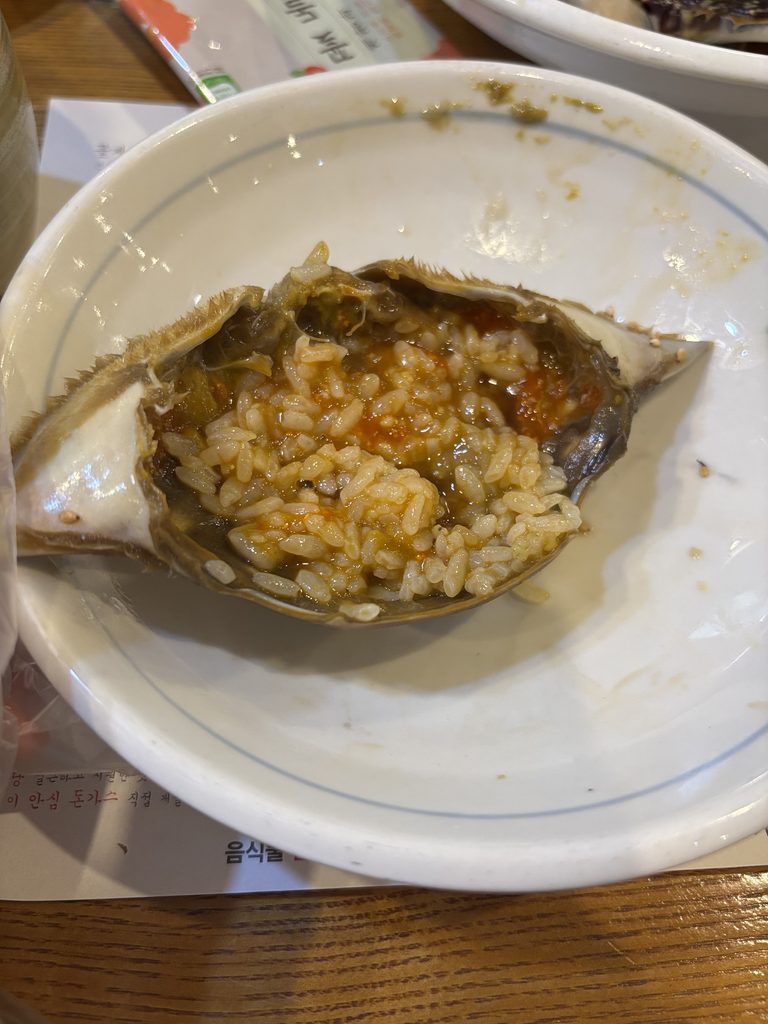 Rice mixed with crab roe inside a crab shell